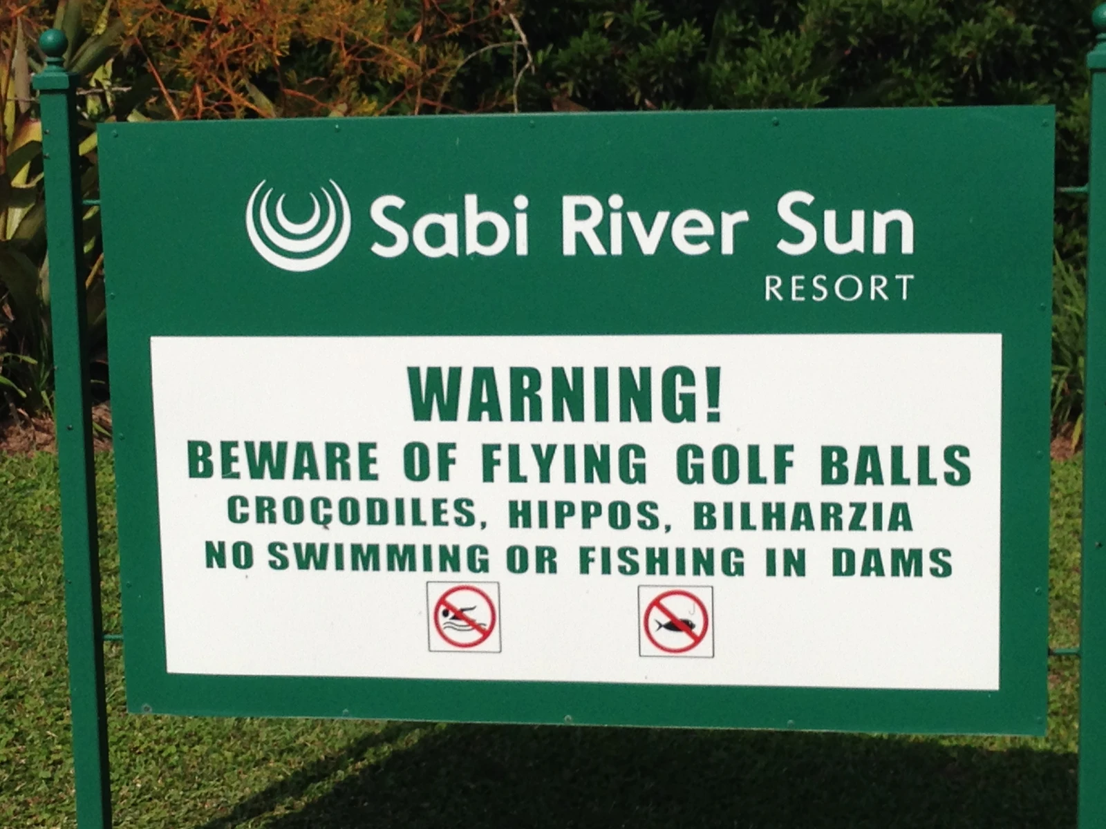 A course sign warning of crocodiles and hippos